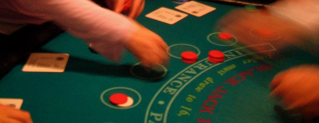 Players' hands and chips at a blackjack table